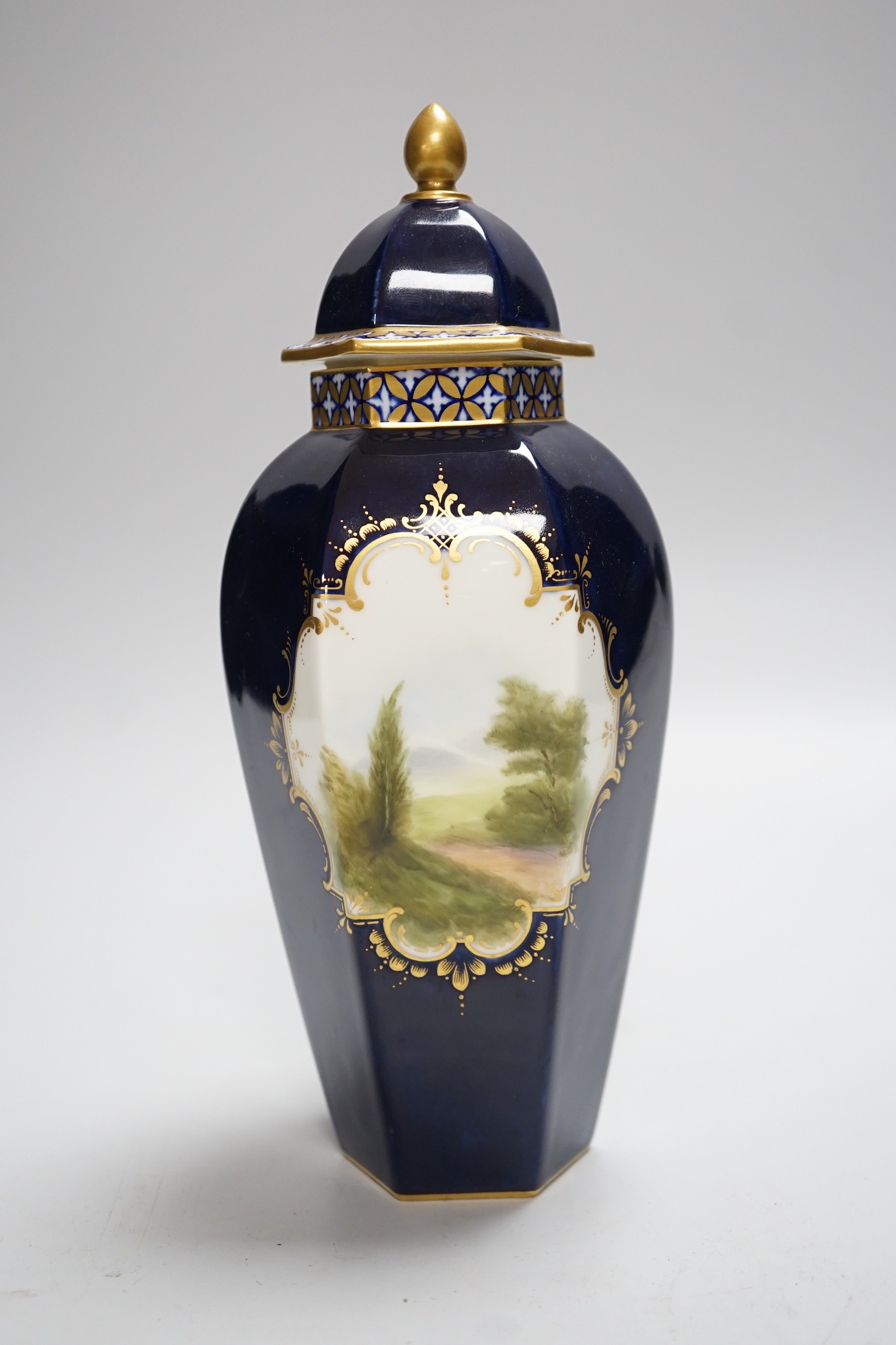 A Royal Worcester landscape painted hexagonal vase and cover signed R.Rushton, 24cm